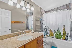 Bathroom featuring vanity and shower / tub combo with curtain
