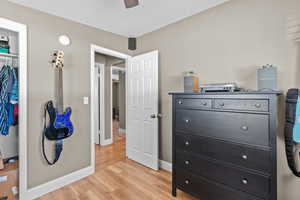 Bedroom featuring light wood-type flooring and a closet