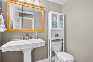 Half bathroom featuring toilet and a sink