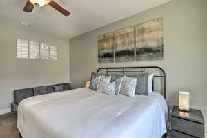 Carpeted bedroom with baseboards and a ceiling fan