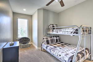 Bedroom featuring carpet floors, baseboards, and a ceiling fan