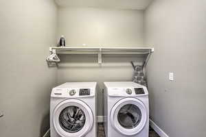 Laundry area featuring washer and clothes dryer and baseboards