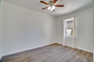 Spare room with light wood-style flooring and a ceiling fan