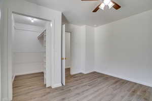 Unfurnished bedroom with wood finished floors and ceiling fan