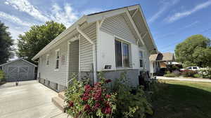 View of property exterior featuring an outbuilding