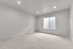 Unfurnished room featuring light carpet and recessed lighting