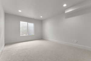 Unfurnished room featuring recessed lighting and carpet floors