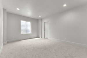 Carpeted spare room with recessed lighting and a textured ceiling