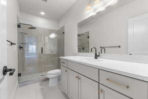 Bathroom with vanity, a shower stall, recessed lighting, and light tile patterned flooring