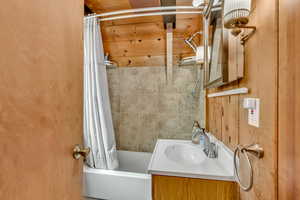 Bathroom featuring vanity and shower / bath combo