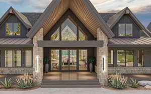 Entrance to property featuring a standing seam roof, stone siding, and a metal roof