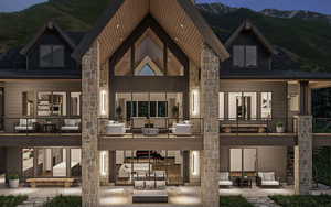 Back of property featuring an outdoor living space, a mountain view, a patio, a standing seam roof, and board and batten siding