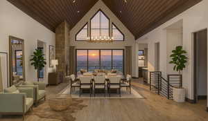 Dining space featuring wood finished floors, high vaulted ceiling, wooden ceiling, a water view, and a chandelier