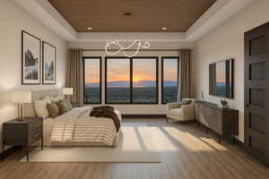Bedroom with wooden ceiling, a raised ceiling, multiple windows, light wood finished floors, and recessed lighting