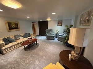 Living area with carpet and recessed lighting