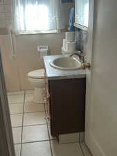 Bathroom with tile patterned flooring and vanity