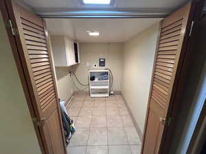 Laundry area with washer hookup and light tile patterned floors