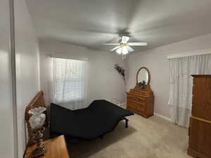 Bedroom featuring light colored carpet and ceiling fan