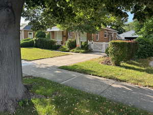 Obstructed view of property with brick siding and a gate