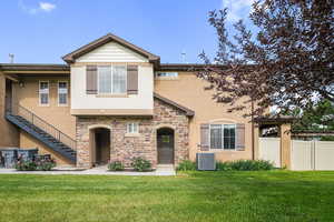 View of property with stucco siding and stone siding