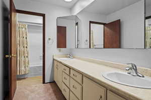 Full bath with double vanity and shower / bath combo