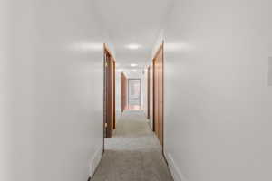 Hall with light colored carpet