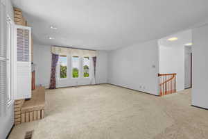 Empty room featuring carpet flooring and a textured ceiling