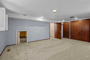 Finished below grade area featuring carpet flooring and recessed lighting