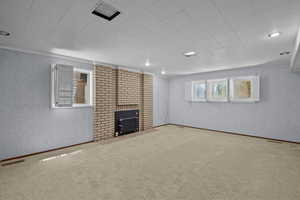 Unfurnished living room with carpet flooring, a wood stove, and recessed lighting