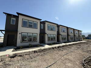 Multi unit property featuring stucco siding and brick siding