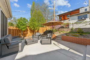 Fenced backyard  patio, grill area, and garden