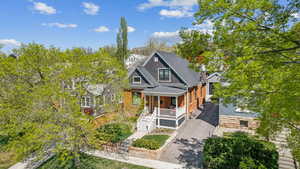 View of front facade featuring the porch, asphalt driveway