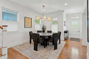 Dining space with oak hardwood flooring, chandelier, and recessed lighting