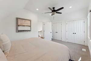 Primary bedroom featuring carpet floors, double closets