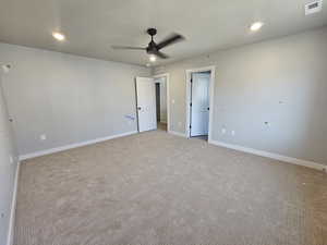 Unfurnished bedroom with light carpet, recessed lighting, and a ceiling fan