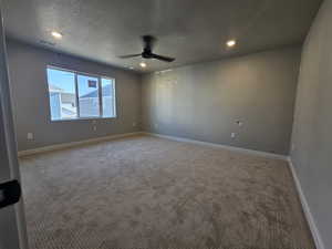 Unfurnished room featuring ceiling fan, carpet flooring, a textured ceiling, and recessed lighting