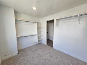 Unfurnished bedroom with carpet flooring, a closet, and a textured ceiling