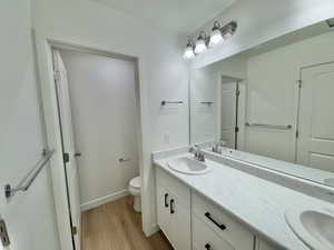 Bathroom with wood finished floors and double vanity