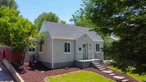 View of front of house with a shingled roof