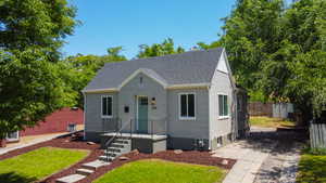 Bungalow-style house with a shingled roof and a chimney