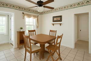 Digitally Staged: Dining room with ceiling fan and light tile patterned floors