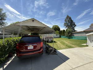 View of vehicle parking with a detached carport