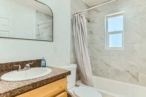 Bathroom featuring vanity and shower / tub combo