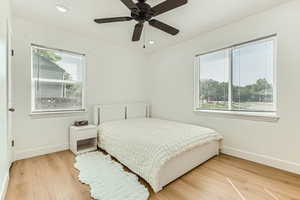 Bedroom with light wood-style flooring, recessed lighting, and a ceiling fan