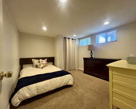 Bedroom featuring light colored carpet and recessed lighting