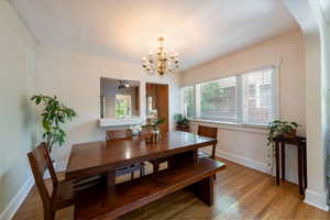 Dining space with a chandelier and light wood finished floors