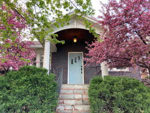Property entrance featuring brick siding