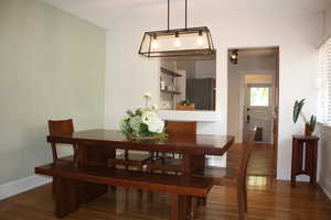 Dining area with dark wood finished floors and baseboards