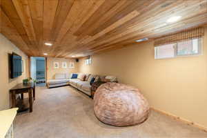 Living room featuring carpet flooring, wooden ceiling, healthy amount of natural light, and recessed lighting