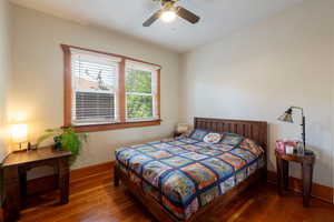 Bedroom with hardwood / wood-style flooring and a ceiling fan